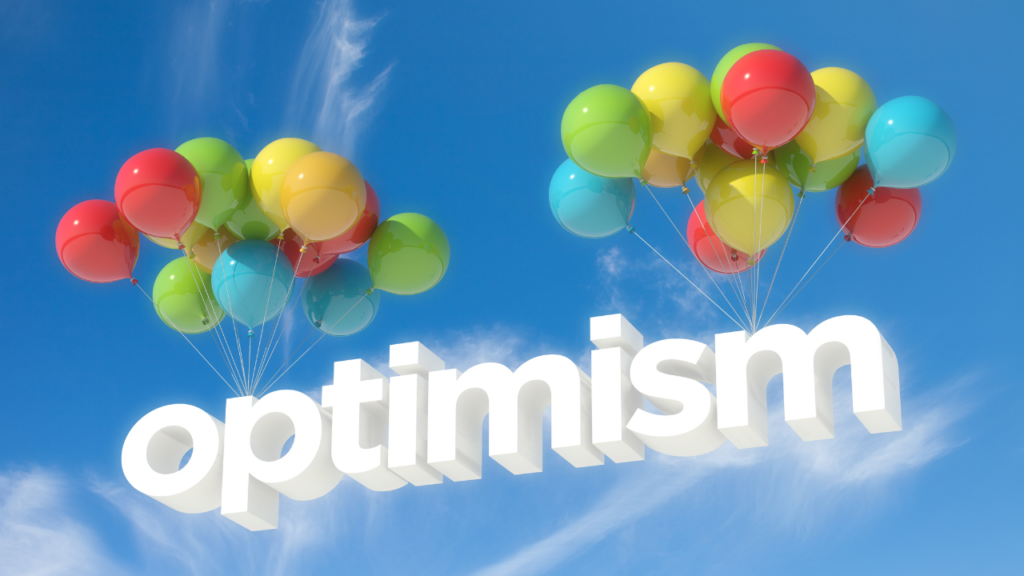 photo showing balloons and blue sky with optimism word displayed